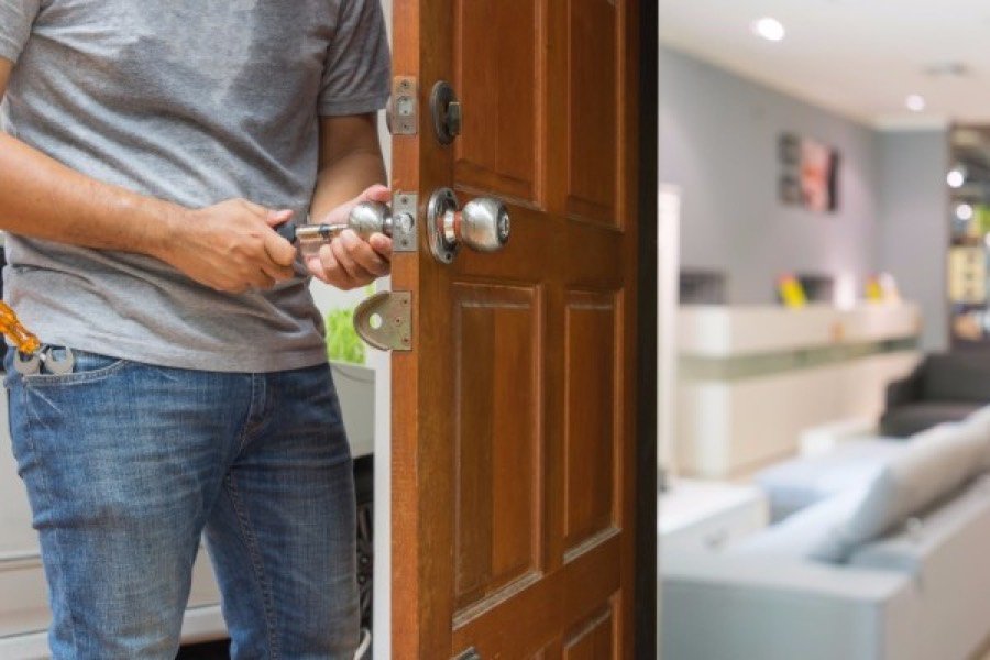 Residential locksmith installing a door lock in a Las Vegas home